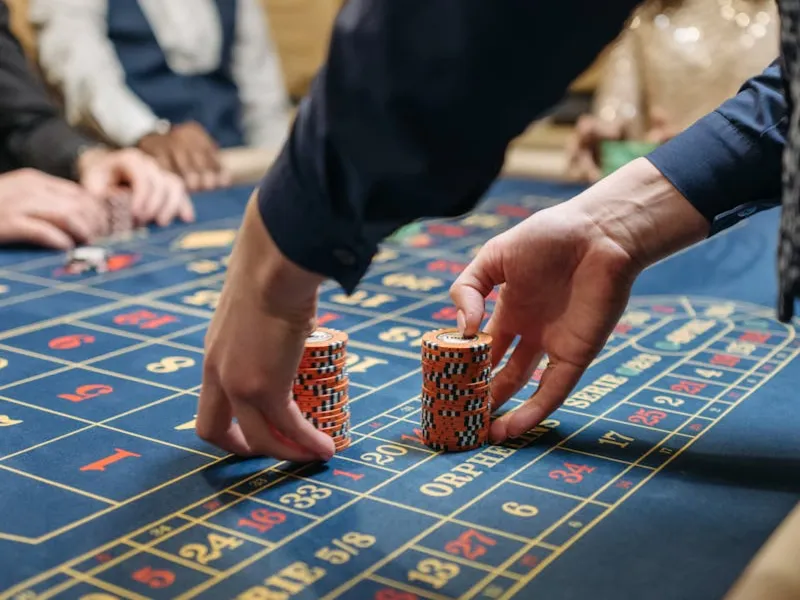 Stylish gaming hall showing a concentrated user at a roulette station — the iconic 9777bet look.