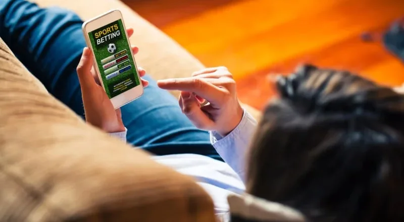 Busy Bangladeshi sports fan following live cricket data across several devices.